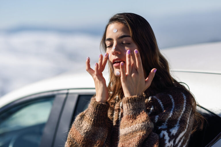 woman applying sunscreen